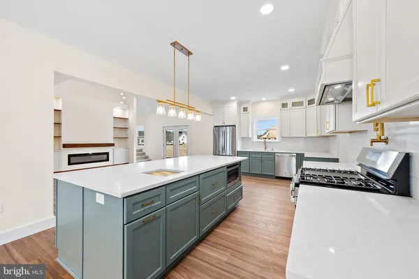a view of a room with wooden floor and white walls