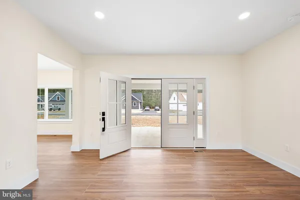 a view of a kitchen with wooden floor and a window