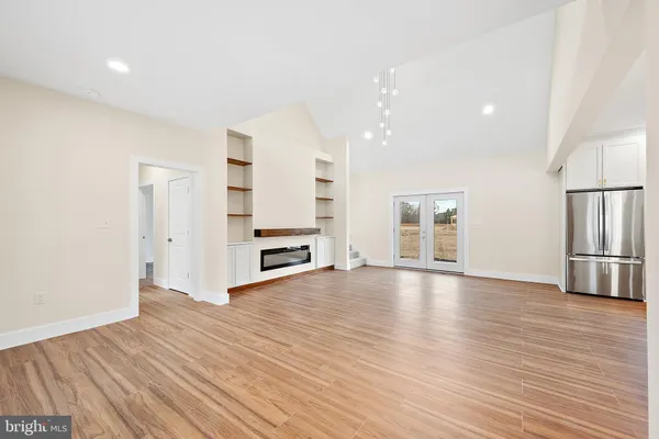 a kitchen with stainless steel appliances a sink cabinets and wooden floor