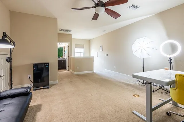 a view of a livingroom with furniture and a chandelier fan