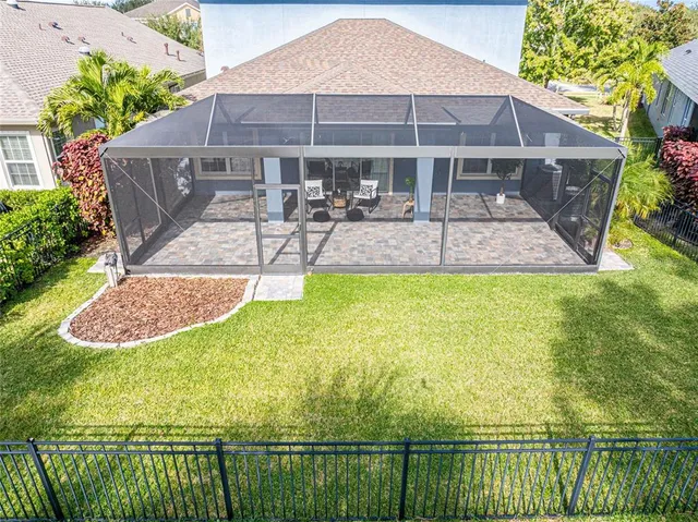 a view of a house with swimming pool and sitting area