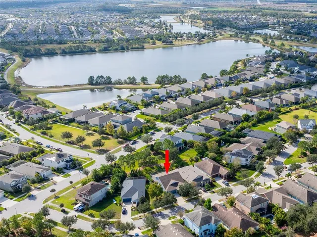 an aerial view of residential house with yard and swimming pool