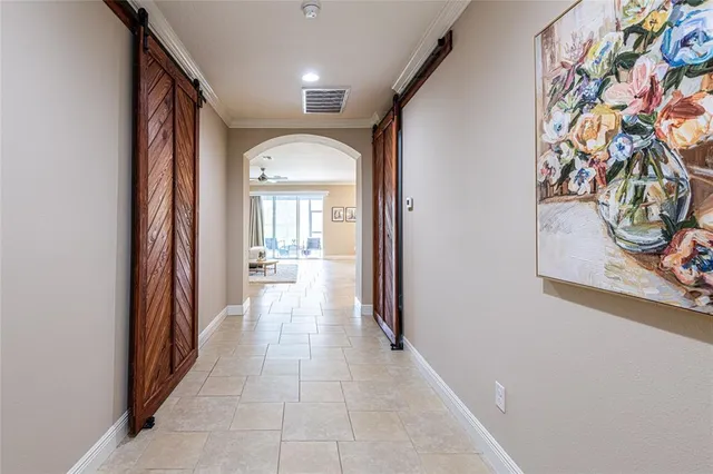 a view of a hallway to filled with wooden floor and a painting on the wall
