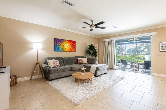 a living room with furniture a flat screen tv and a large window