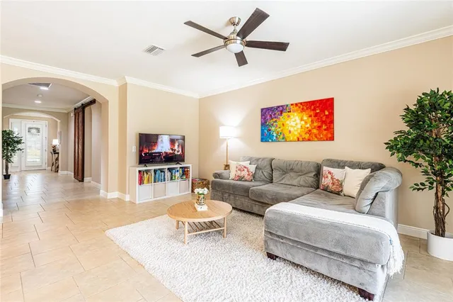 a living room with furniture and a flat screen tv