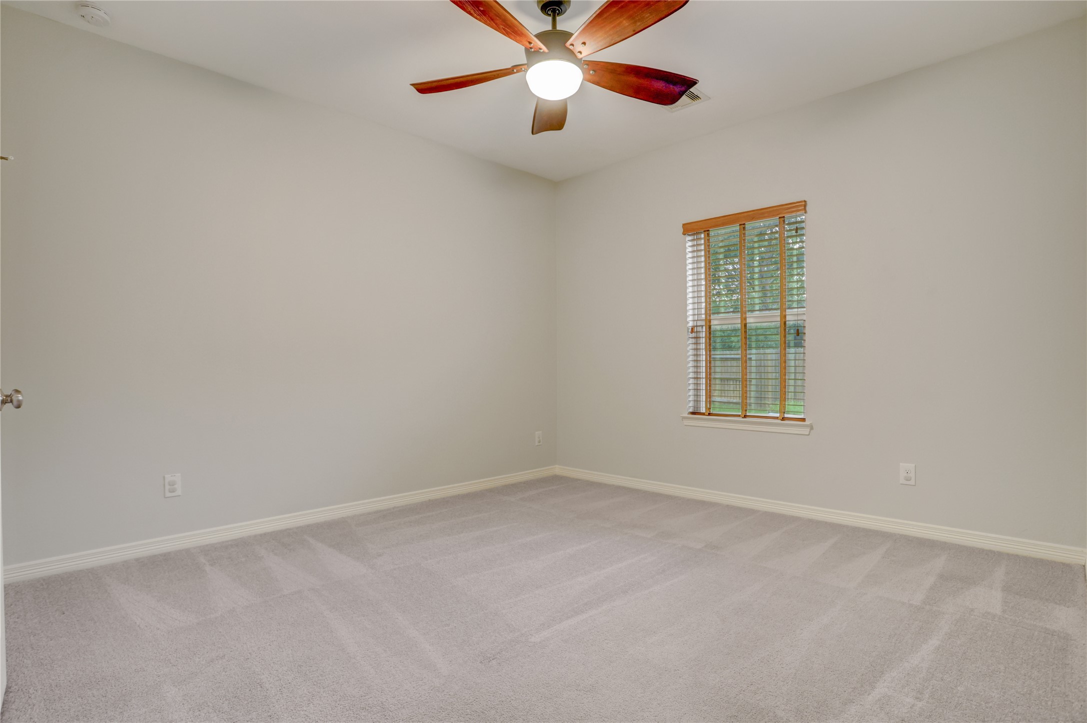 3002 Currant Drive Manvel, TX 77578 - Photo 26 of 43 an empty room with windows and fan