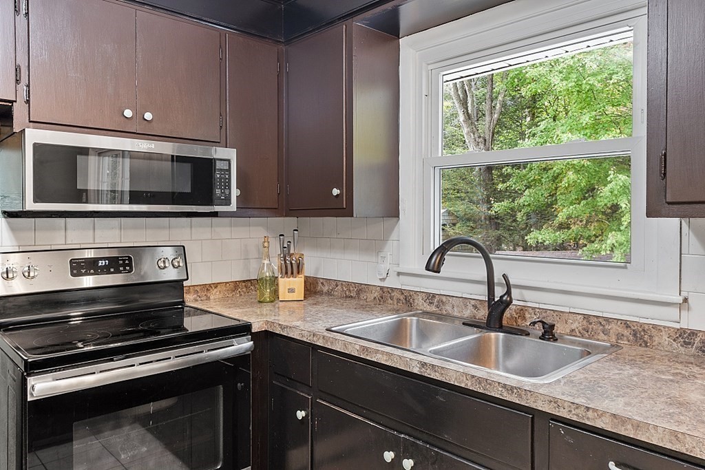 8 Anthony Drive Rutland, MA 01543 - Photo 5 of 30 a kitchen with granite countertop a sink and stainless steel appliances