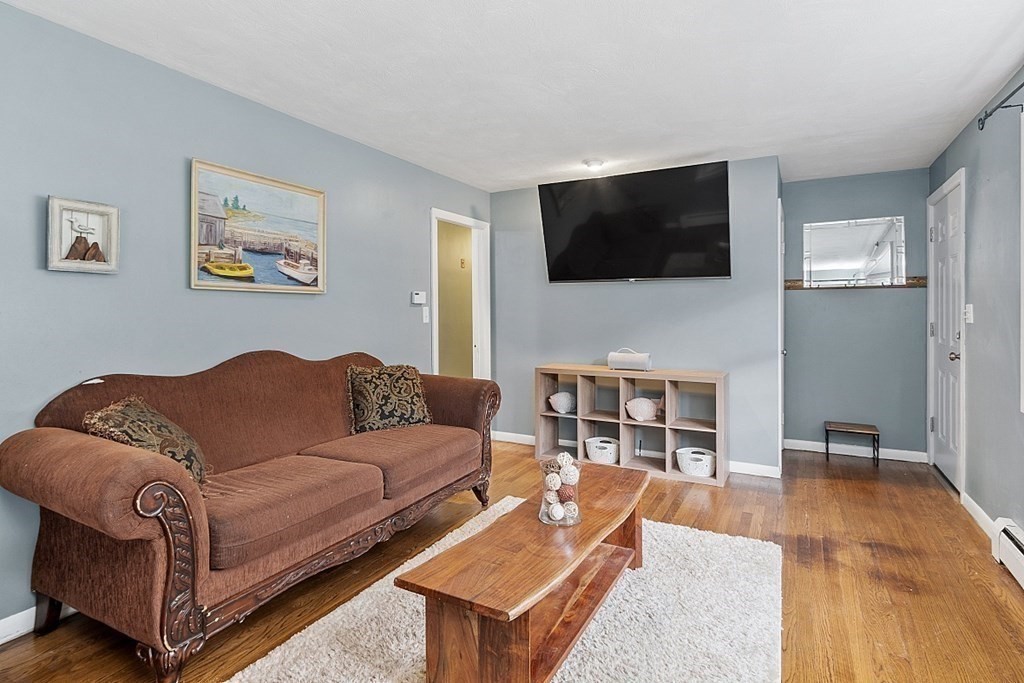 8 Anthony Drive Rutland, MA 01543 - Photo 10 of 30 a living room with a couch and a flat screen tv
