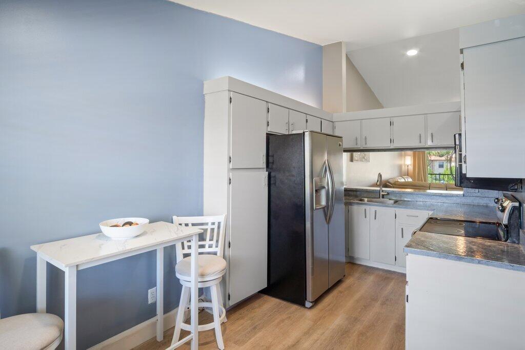 1402 Pinecrest Circle, Unit B Jupiter, FL 33458 - Photo 12 of 56 a kitchen with a sink a refrigerator and wooden floor