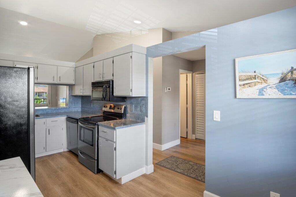 1402 Pinecrest Circle, Unit B Jupiter, FL 33458 - Photo 15 of 56 a kitchen with stainless steel appliances granite countertop a stove a refrigerator and a microwave