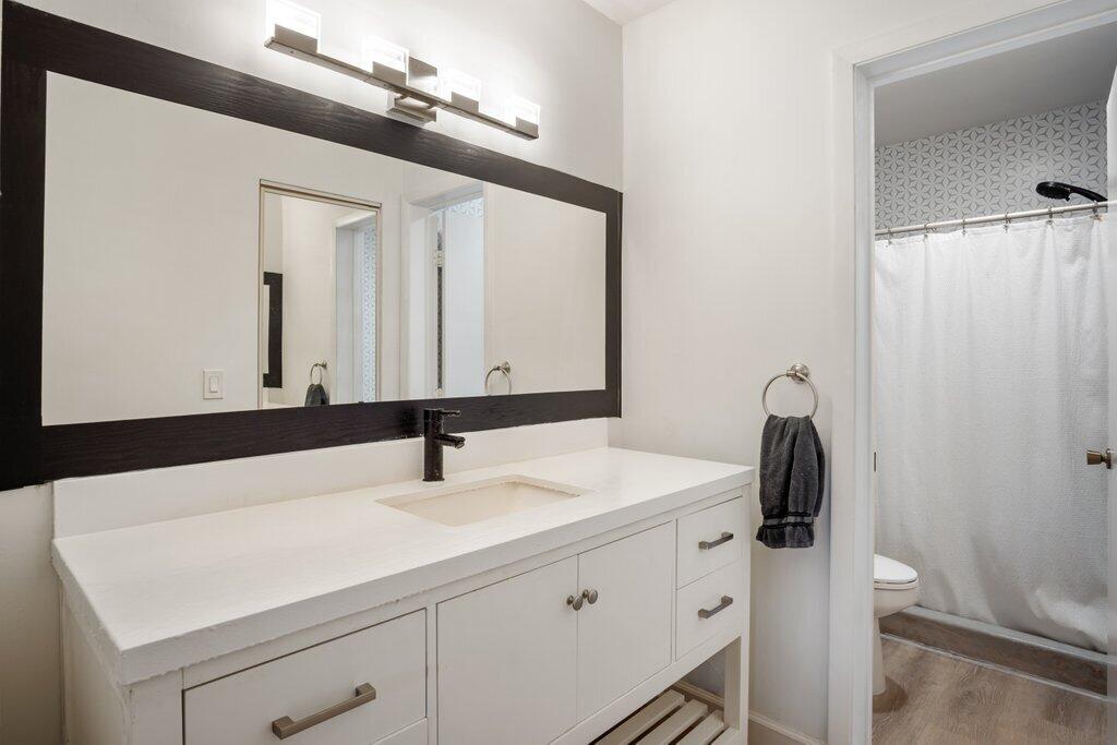 1402 Pinecrest Circle, Unit B Jupiter, FL 33458 - Photo 23 of 56 a bathroom with a sink vanity and a mirror