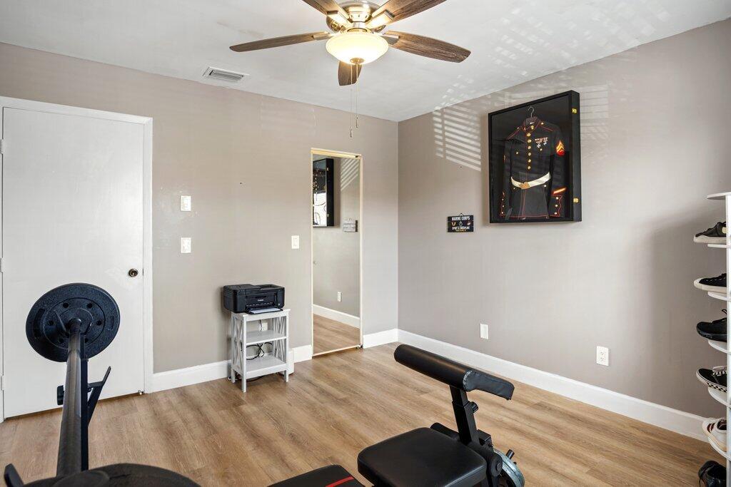1402 Pinecrest Circle, Unit B Jupiter, FL 33458 - Photo 27 of 56 a view of a workspace with furniture and a chandelier fan