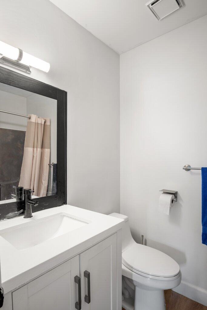 1402 Pinecrest Circle, Unit B Jupiter, FL 33458 - Photo 30 of 56 a bathroom with a toilet sink and mirror