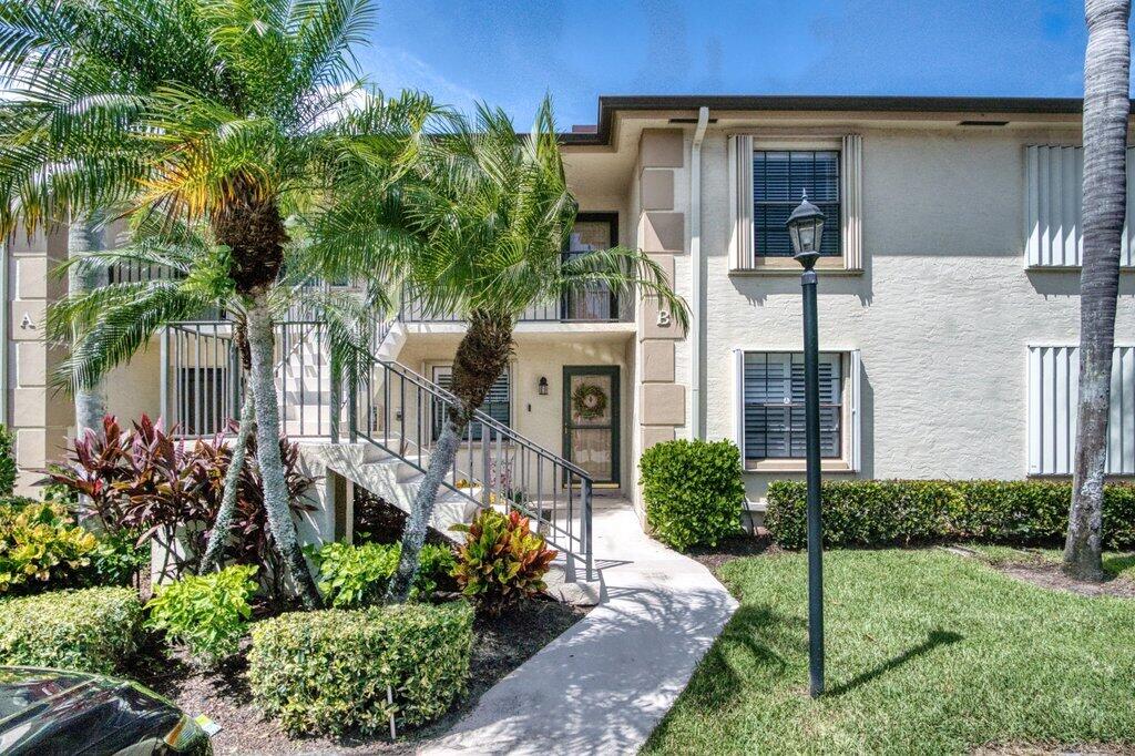 1402 Pinecrest Circle, Unit B Jupiter, FL 33458 - Photo 3 of 56 a front view of a house with a yard