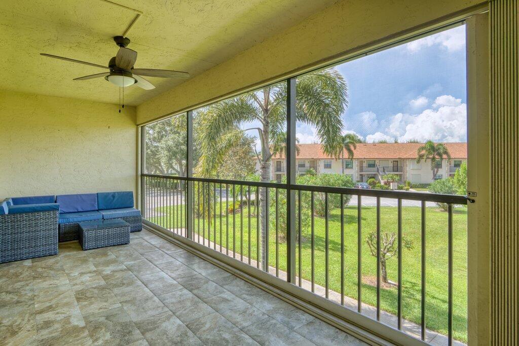 1402 Pinecrest Circle, Unit B Jupiter, FL 33458 - Photo 33 of 56 a view of a porch and a floor to ceiling window