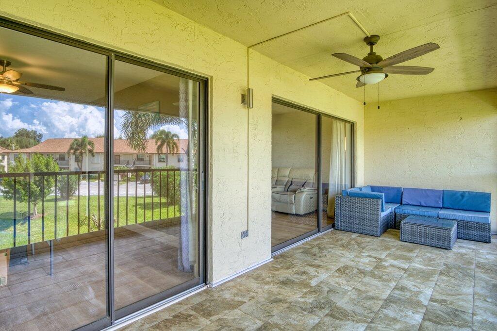 1402 Pinecrest Circle, Unit B Jupiter, FL 33458 - Photo 34 of 56 a bedroom with a bed and glass walk in closet