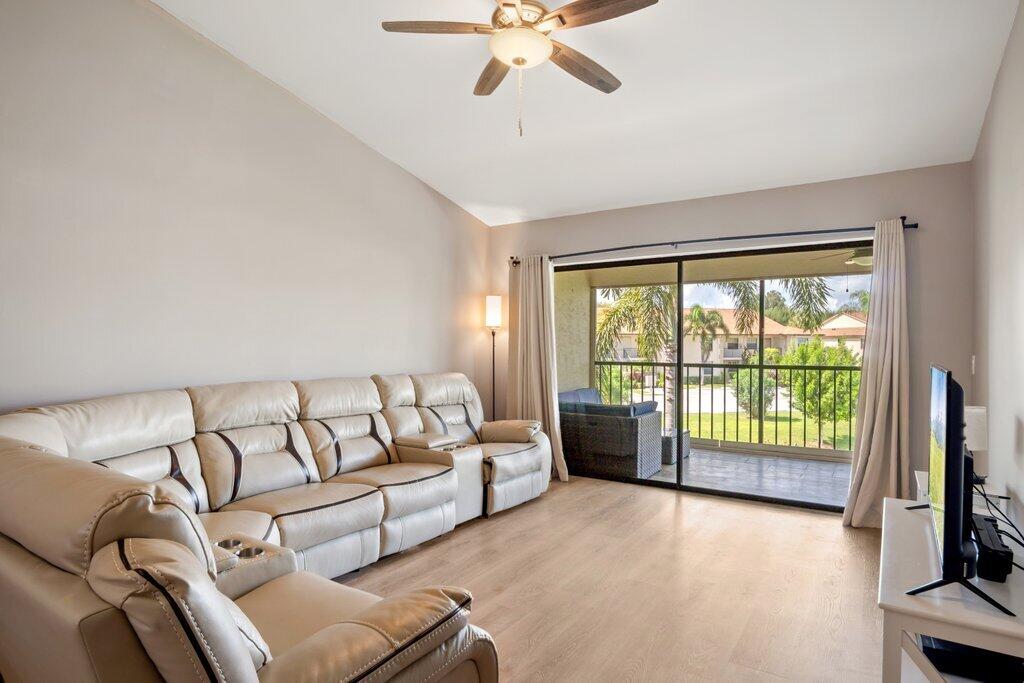 1402 Pinecrest Circle, Unit B Jupiter, FL 33458 - Photo 4 of 56 a living room with furniture and a flat screen tv