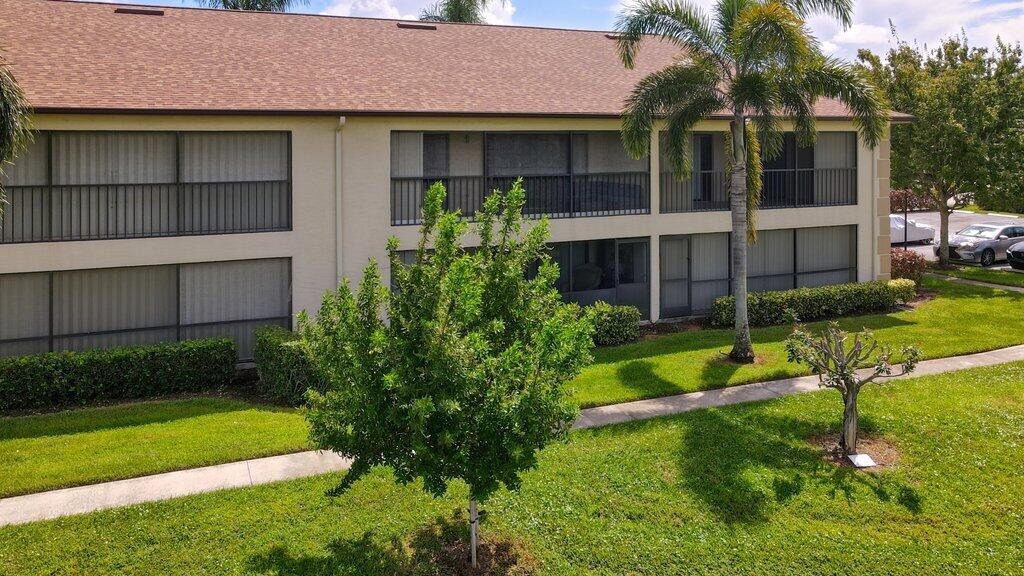1402 Pinecrest Circle, Unit B Jupiter, FL 33458 - Photo 41 of 56 a view of a brick house with a yard and plants