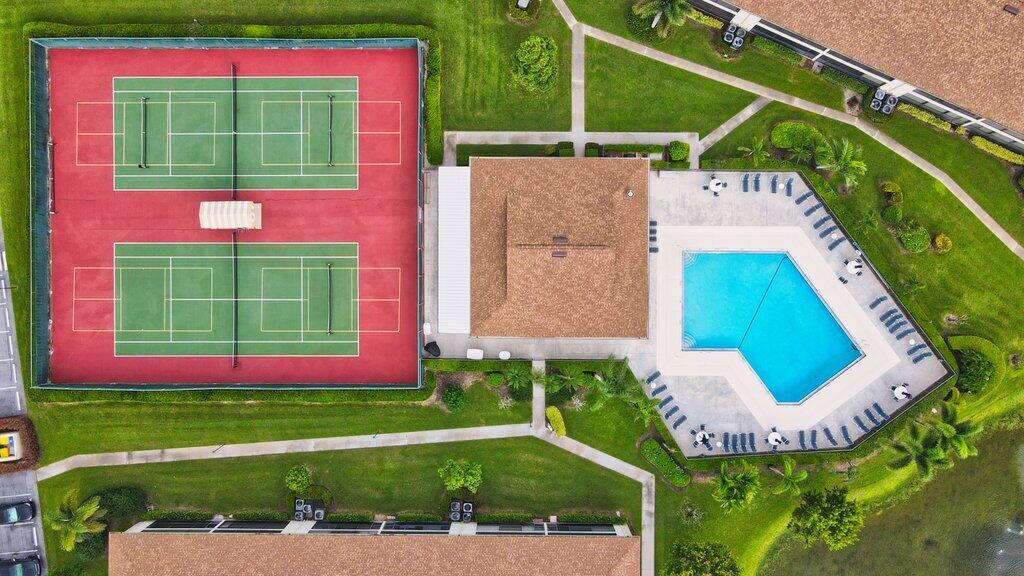 1402 Pinecrest Circle, Unit B Jupiter, FL 33458 - Photo 43 of 56 a view of a house with a swimming pool