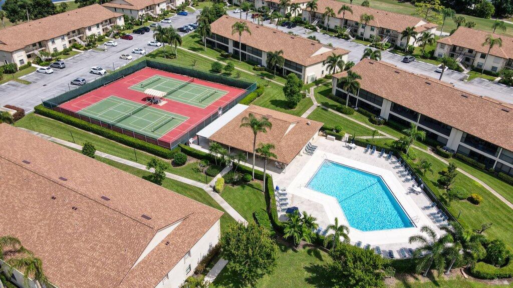 1402 Pinecrest Circle, Unit B Jupiter, FL 33458 - Photo 44 of 56 an aerial view of a tennis ground and a cars park side of the road