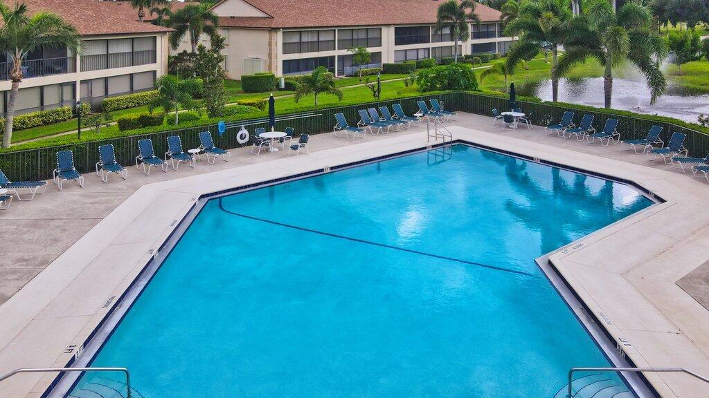 1402 Pinecrest Circle, Unit B Jupiter, FL 33458 - Photo 46 of 56 a view of a swimming pool with a patio