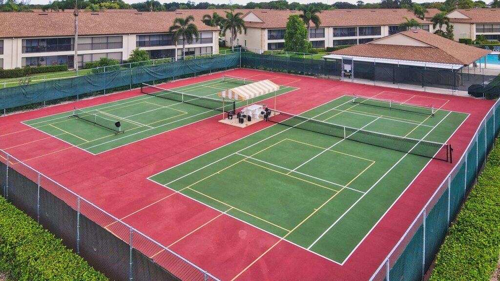 1402 Pinecrest Circle, Unit B Jupiter, FL 33458 - Photo 47 of 56 a green field with lots of trees in front of it