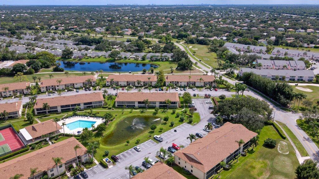 1402 Pinecrest Circle, Unit B Jupiter, FL 33458 - Photo 49 of 56 an aerial view of a houses with a swimming pool