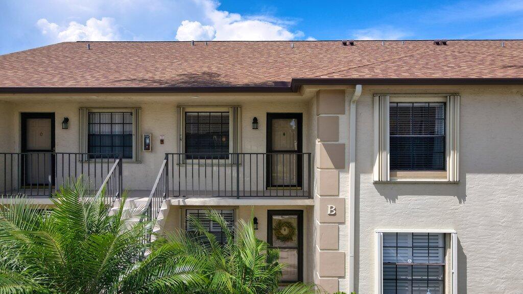1402 Pinecrest Circle, Unit B Jupiter, FL 33458 - Photo 54 of 56 a front view of a house with a garden