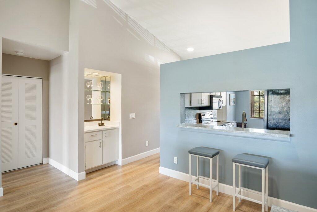 1402 Pinecrest Circle, Unit B Jupiter, FL 33458 - Photo 9 of 56 a kitchen with stainless steel appliances granite countertop a stove and cabinets