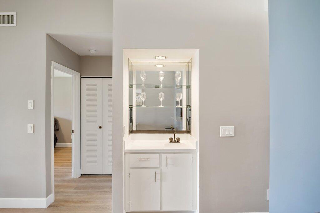 1402 Pinecrest Circle, Unit B Jupiter, FL 33458 - Photo 10 of 56 a bathroom with a sink a mirror and shower