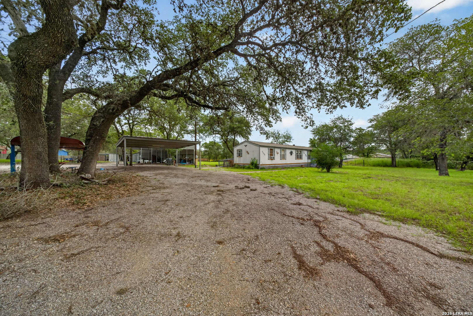 23398 Mathis Road Elmendorf, TX 78112 - Photo 4 of 18 a view of a house with a yard