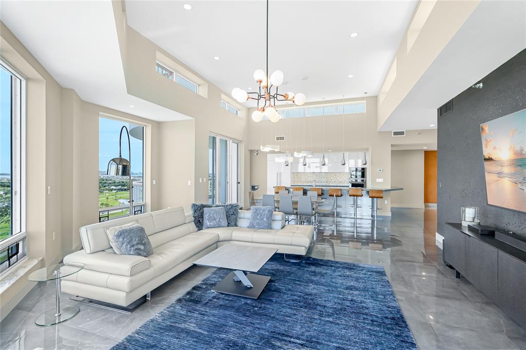 455 Longboat Club Road, Unit PH8 Longboat Key, FL 34228 - Photo 12 of 64 a living room with lots of furniture and a chandelier