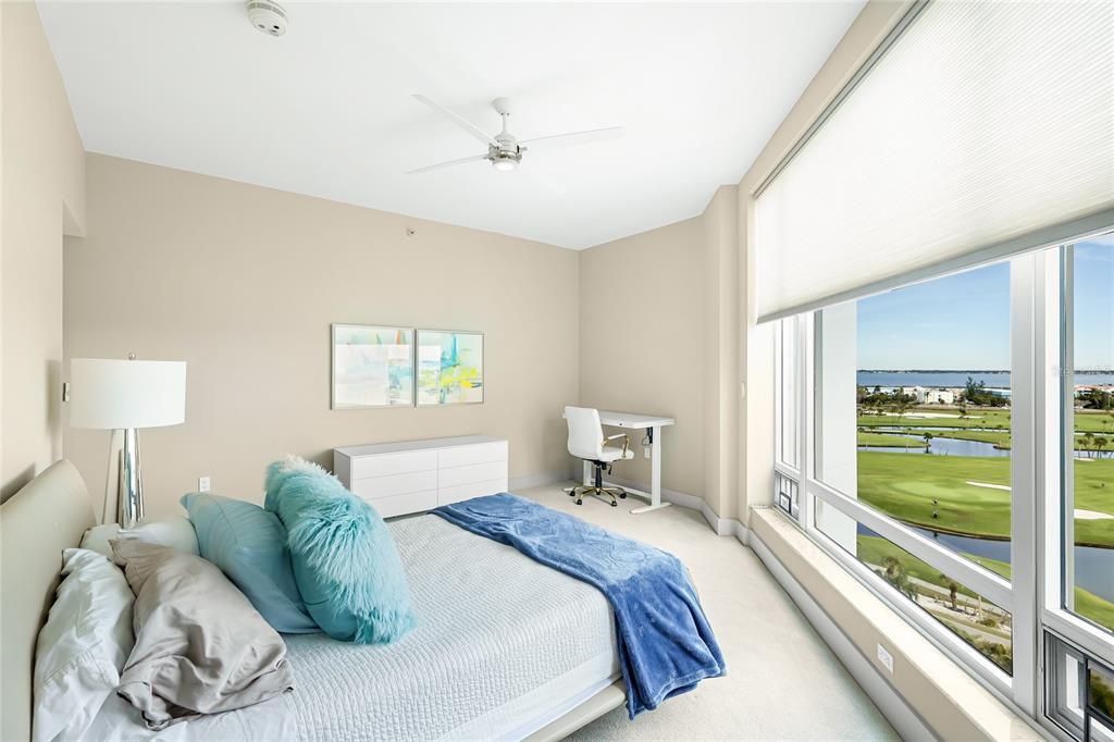 455 Longboat Club Road, Unit PH8 Longboat Key, FL 34228 - Photo 24 of 64 a bedroom with a bed and a lamp