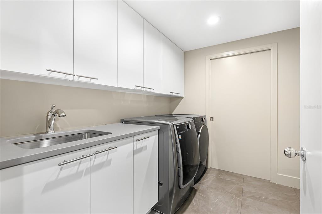 455 Longboat Club Road, Unit PH8 Longboat Key, FL 34228 - Photo 26 of 64 a utility room with dryer and washer