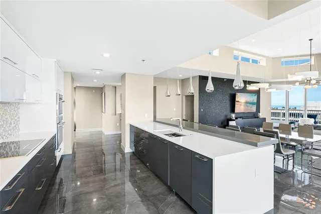 a large kitchen with a large counter top appliances and cabinets