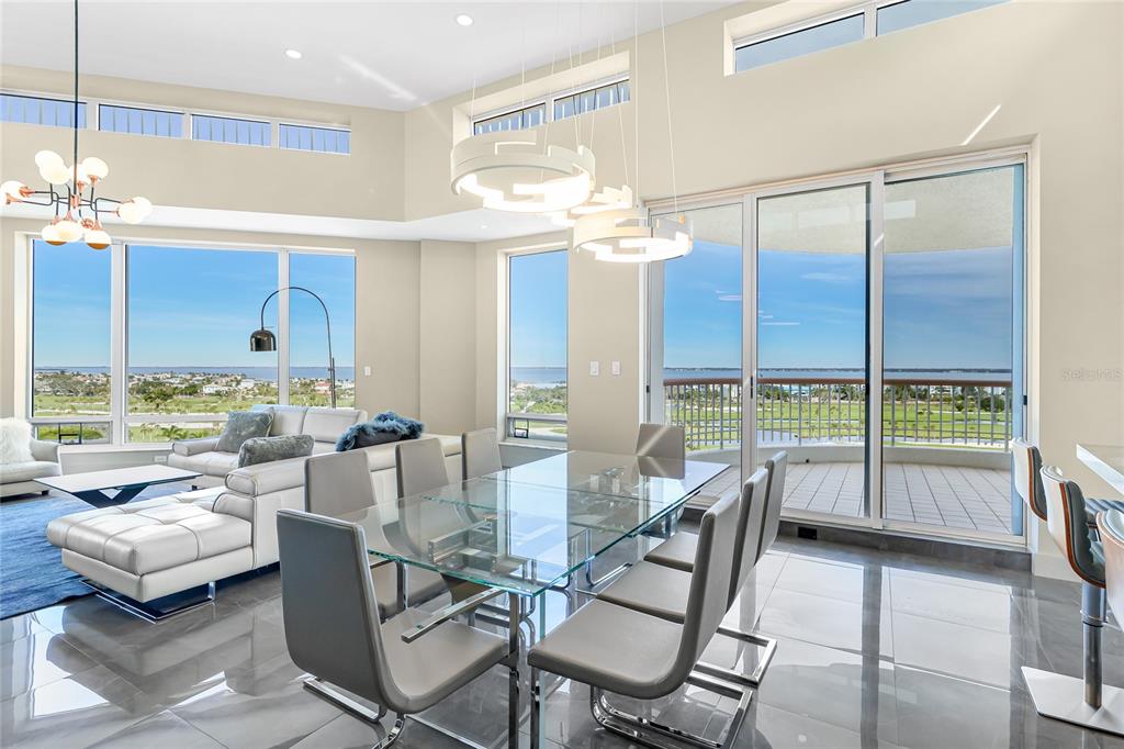 455 Longboat Club Road, Unit PH8 Longboat Key, FL 34228 - Photo 9 of 64 a dining room with furniture and a floor to ceiling window