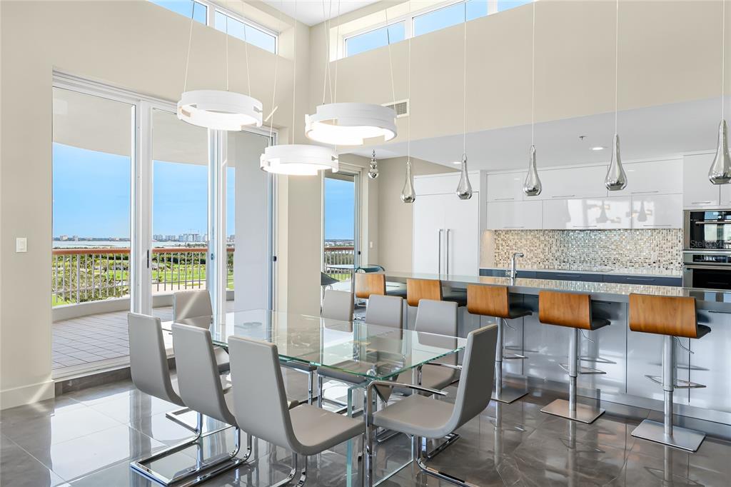 455 Longboat Club Road, Unit PH8 Longboat Key, FL 34228 - Photo 10 of 64 a dining room with furniture and chandelier
