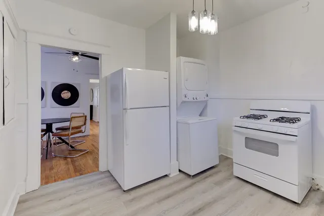 a utility room with cabinets washer and dryer