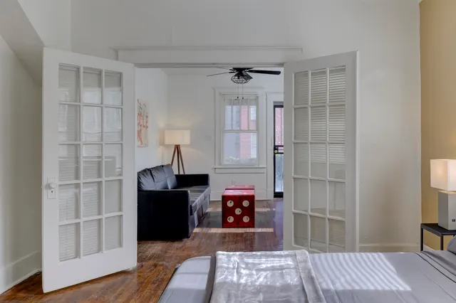 a bedroom with a bed and a chandelier