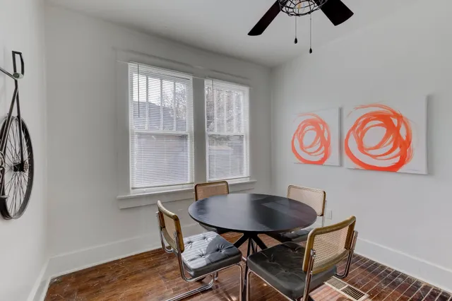 a view of a room that has a table and a chair in it