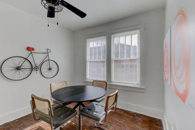 a bedroom with a bed and a lamp on dresser