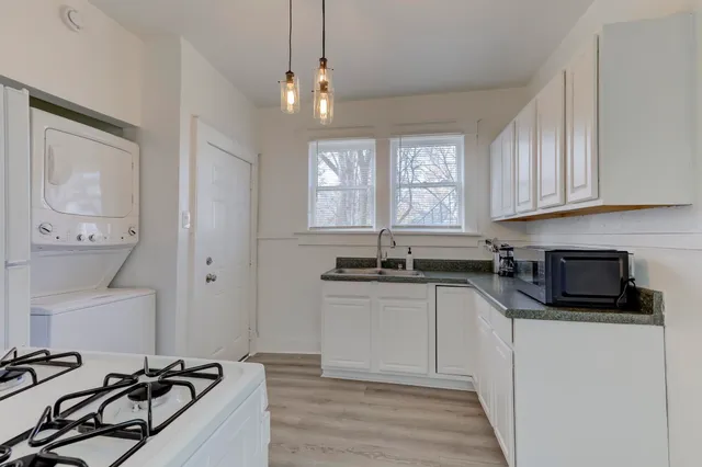a kitchen with white cabinets and a sink