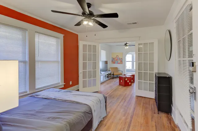 a bedroom with a bed and a chandelier