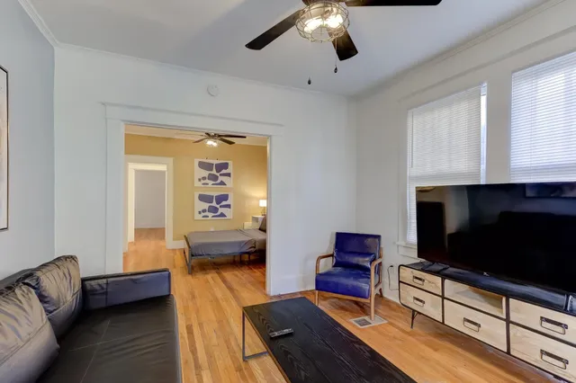 a living room with furniture and a flat screen tv