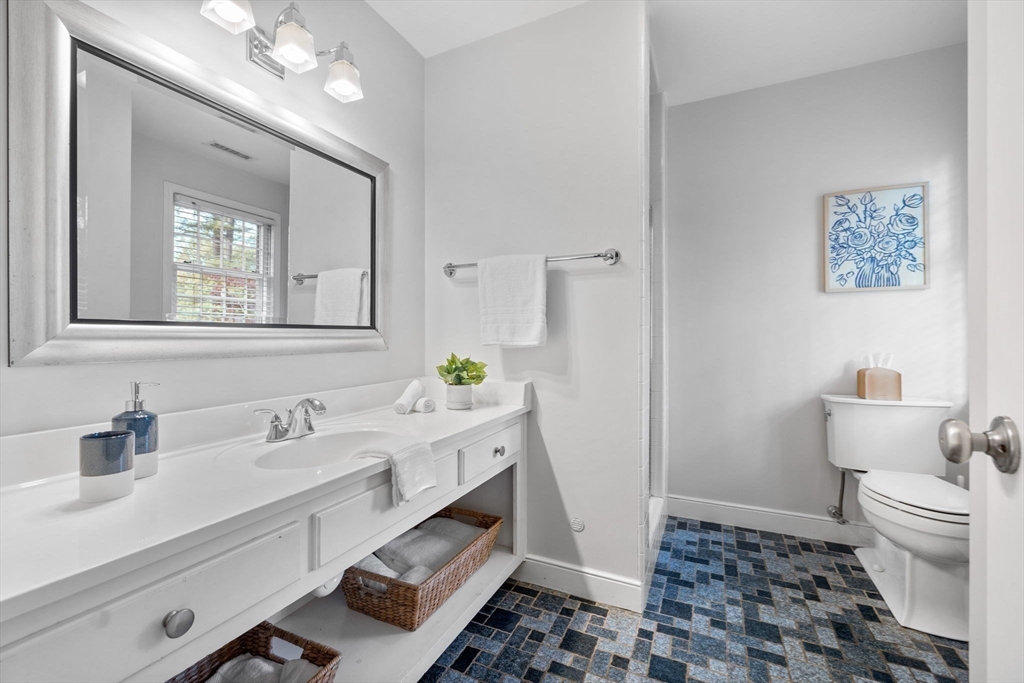 4 Alonesos Way Andover, MA 01810 - Photo 25 of 42 a bathroom with a sink a toilet a mirror and shower