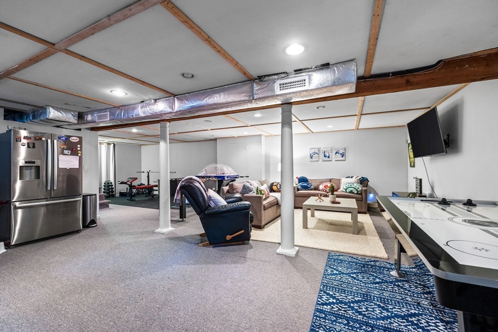 4 Alonesos Way Andover, MA 01810 - Photo 34 of 42 a living room with furniture and a flat screen tv