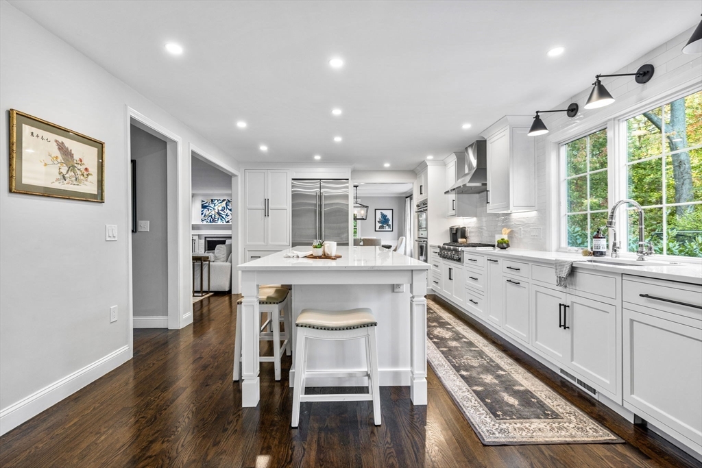 4 Alonesos Way Andover, MA 01810 - Photo 7 of 42 a kitchen with stainless steel appliances granite countertop a refrigerator a sink dishwasher a dining table and chairs with wooden floor