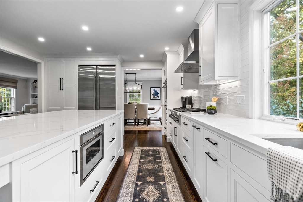 4 Alonesos Way Andover, MA 01810 - Photo 8 of 42 a kitchen with granite countertop white cabinets and white appliances