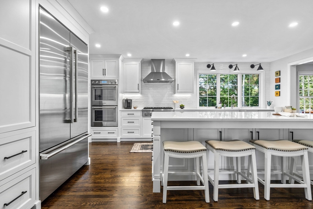 4 Alonesos Way Andover, MA 01810 - Photo 9 of 42 a kitchen with stainless steel appliances granite countertop a table chairs stove and refrigerator