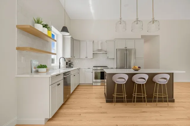 a kitchen with white cabinets and a stainless steel appliances